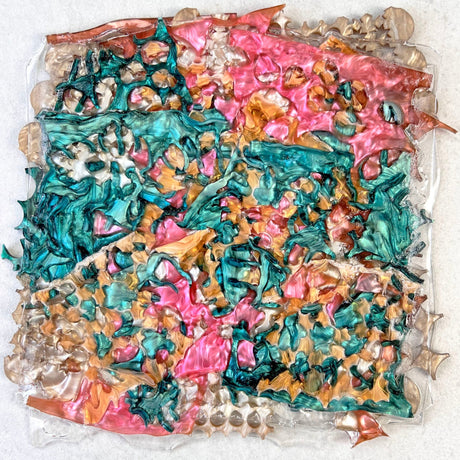 A melt pressed recycled acrylic sheet showing a randomised assortment of green, pink and caramel coloured acrylic scraps pressed within.