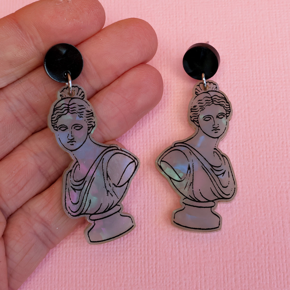 Roman bust earrings in hand
