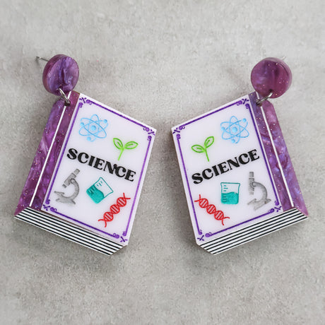 Science-themed texbook earrings with purple colour scheme