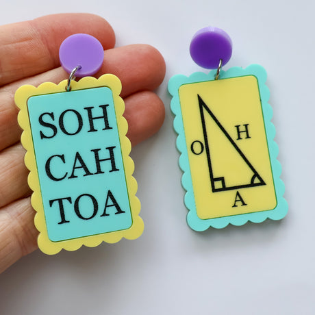 Asymmetrical blue and yellow earrings with 'SOH CAH TOA' and trigonometric triangle design with purple toppers in hand