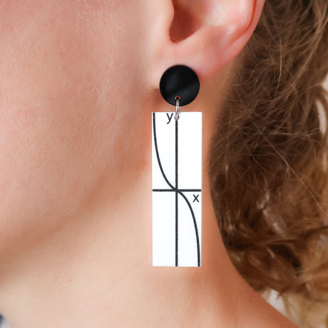 Rectangular acrylic dangles with tan graph printed in black against a white background, and black earring topper. Being modelled. 