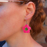 Bright pink Tee tree merinda earrings being modelled. Earrings hang on French hooks. 