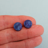 Round twilight acrylic studs in hand