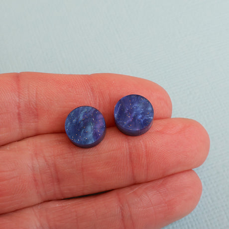 Round twilight acrylic studs in hand