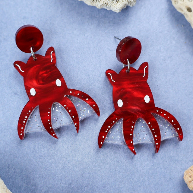 Laser cut acrylic vampire squid earrings, closeup.