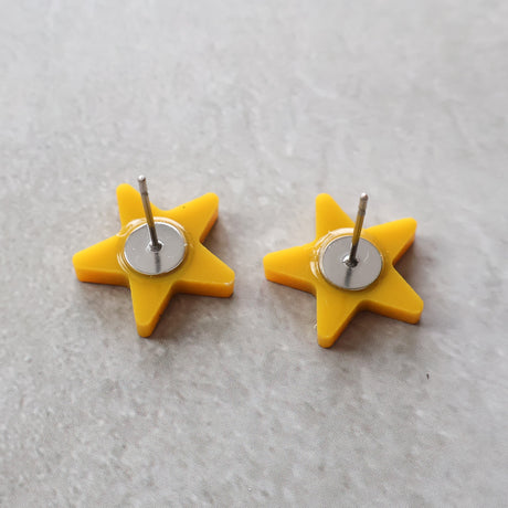 Back view of yellow star studs showing stainless steel earring posts