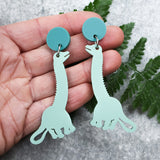 Green diplodocus dangle earrings with darker green toppers. Made from laser cut acrylic. 