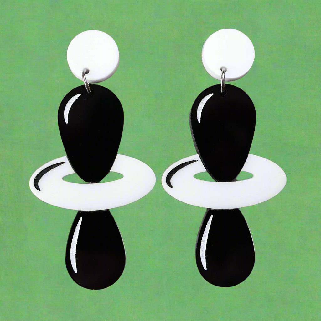 Black and white laser cut acrylic earrings depicting the dz2 electron orbitals. 