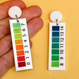 pH indicator earrings in hand