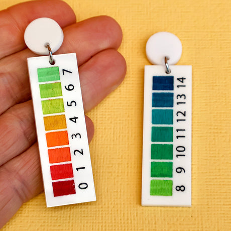 pH indicator earrings in hand