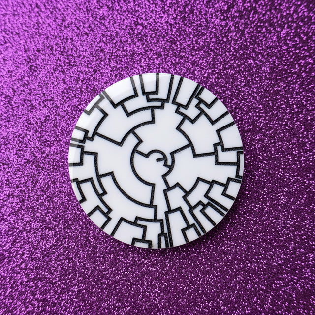 A phylogenetic tree acrylic brooch in black and white. 