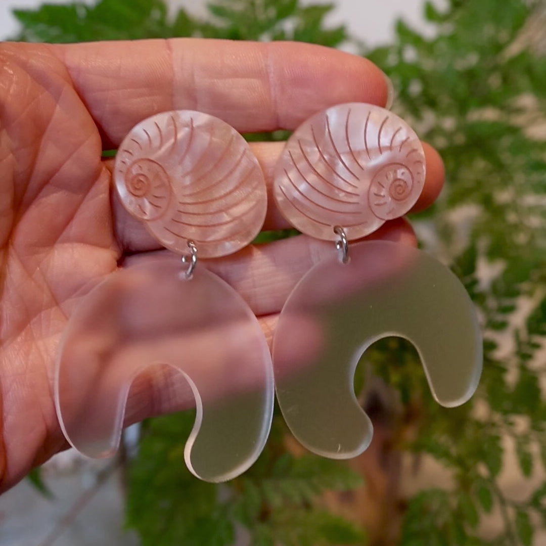 Closeup Video of Acrylic moon snail earrings by Oh Pluto