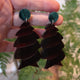 Closeup Video of Acrylic corkscrew shark egg earrings by Oh Pluto
