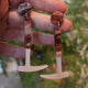Closeup Video of Acrylic fossil hammer earrings by Oh Pluto