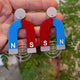 Closeup Video of Acrylic horseshoe magnet earrings by Oh Pluto