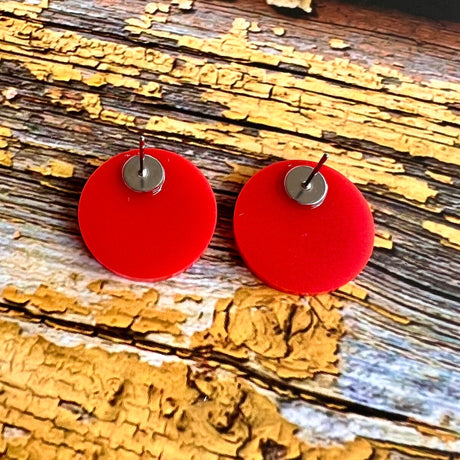 back view of red blood cell stud earrings showing red acrylic and stainless steel earring posts. 