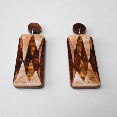 A pair of stalactite and stalagmite earrings in brown acrylics. 