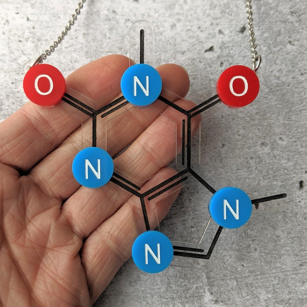 Caffeine Molecule Necklace in Laser Cut Acrylic closeup. With Oxygen red oxygen and blue nitrogen components.