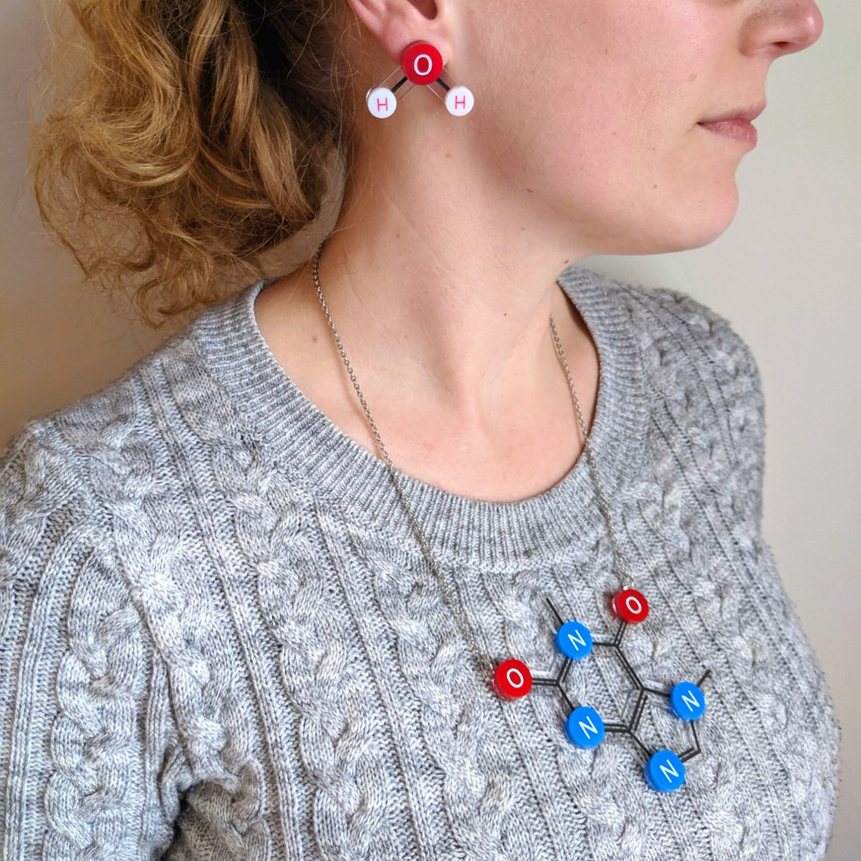 Caffeine Molecule Necklace in Laser Cut Acrylic being modelled. 