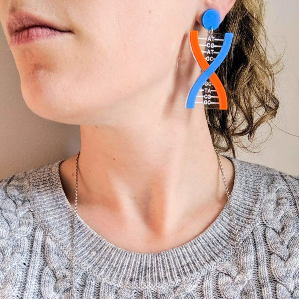 Blue and Orange DNA Acrylic Earrings being modelled. 