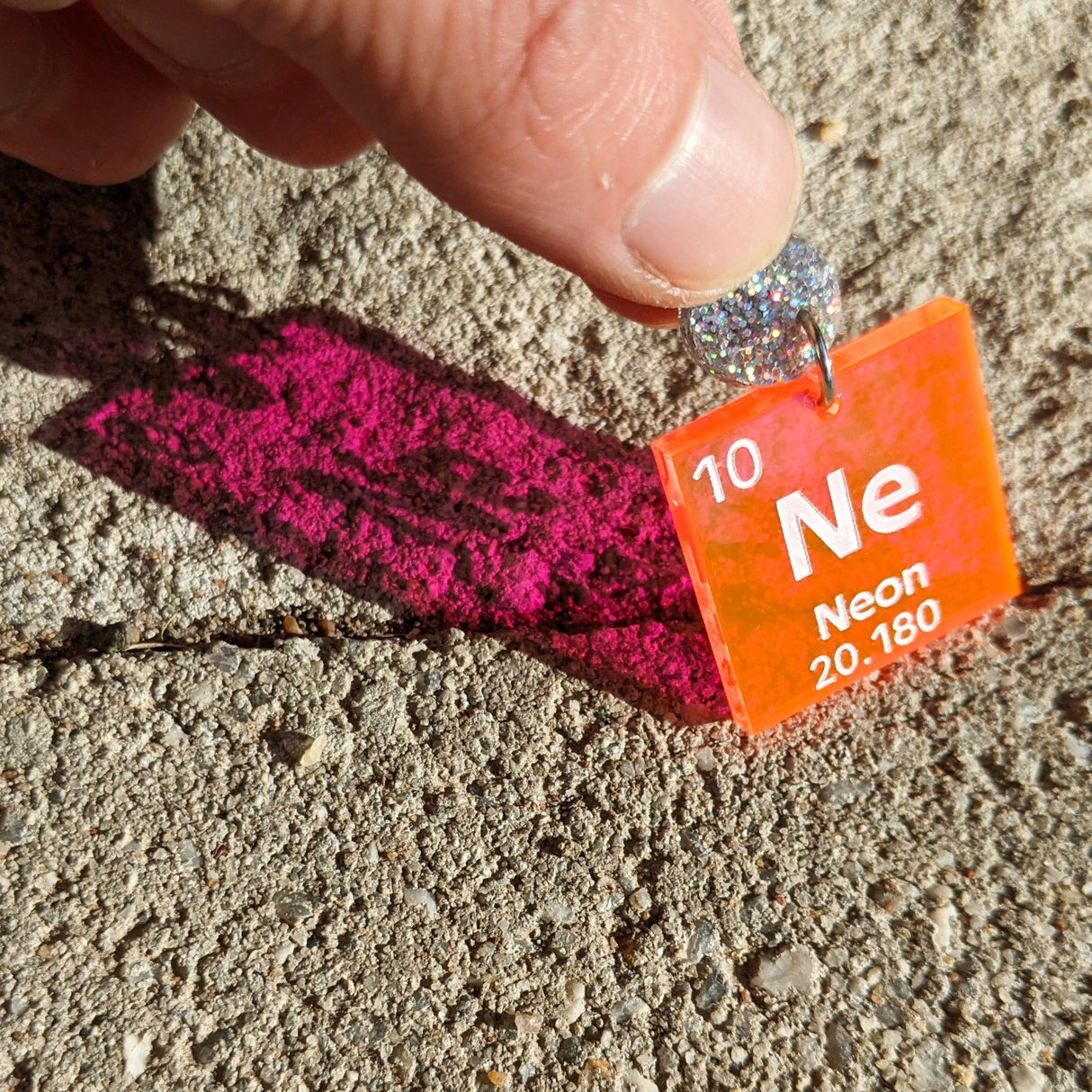 Laser Cut Acrylic Neon Periodic Table Earrings. Clear Orange/Pink Acrylic with silver glitter earring toppers. 