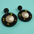 Laser cut acrylic Pluto Earrings showing Tombaugh Regio. Close up view.
