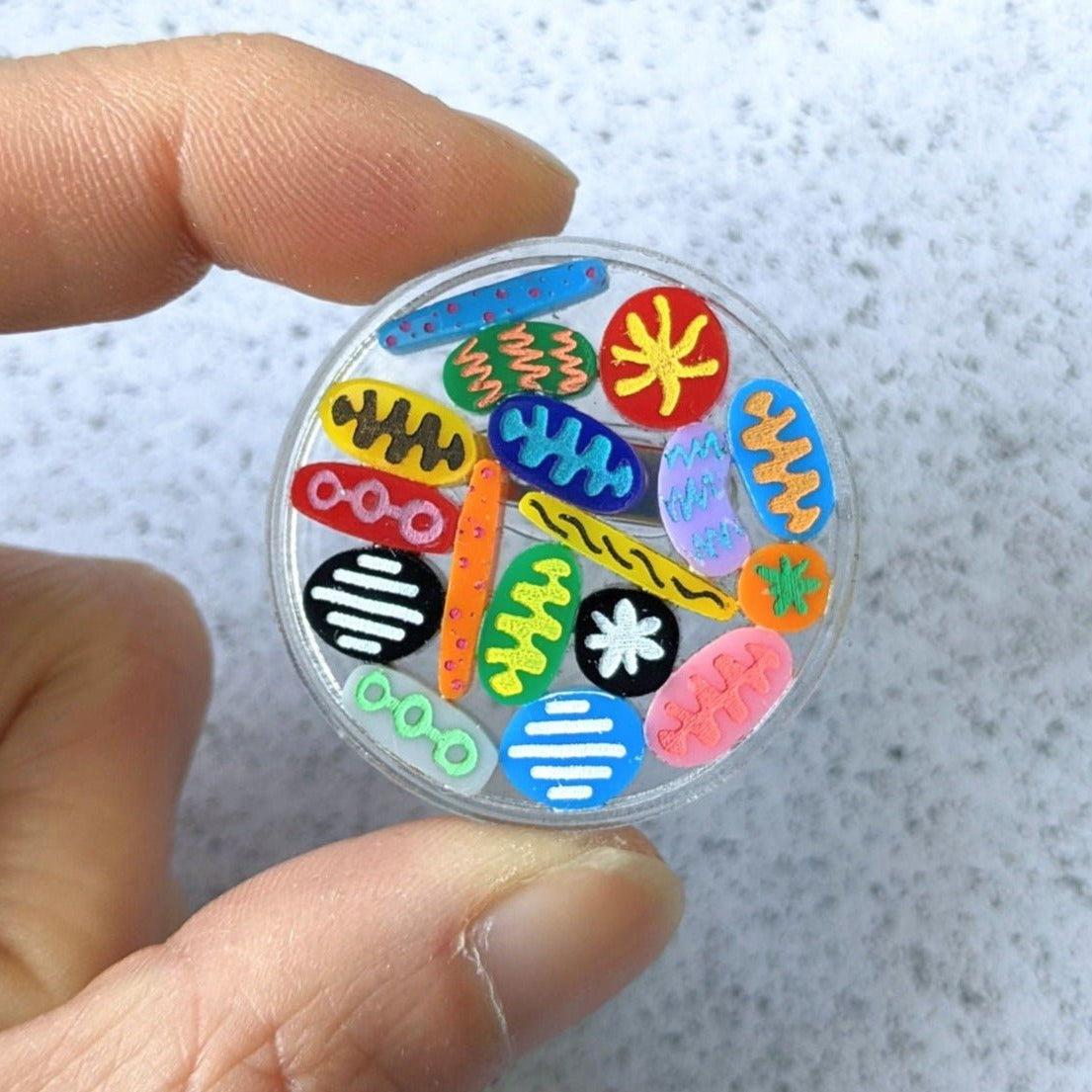 Petri Dish Brooch with tiny microbes. Laser cut in acrylic. 