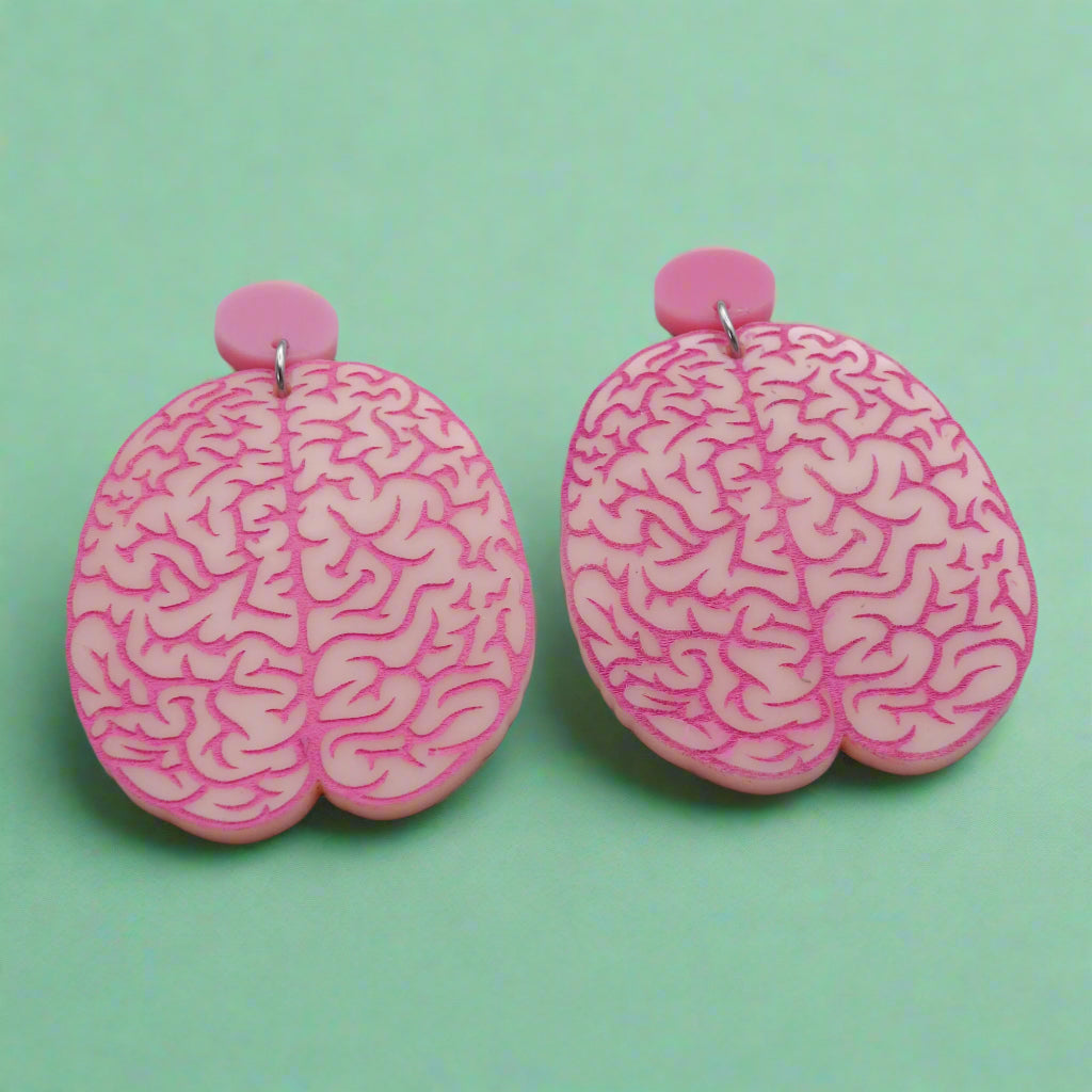 A pair of realistic looking brain earrings in light pink acrylic, with hot pink painted details. Laser cut from acrylic.