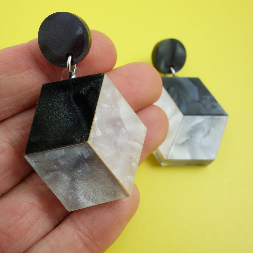 Small greyscale cube earrings made from black, grey and white mineral toned acrylic.
