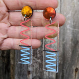 Laser cut acrylic doppler effect earrings, showing red and blue wavelength effects.