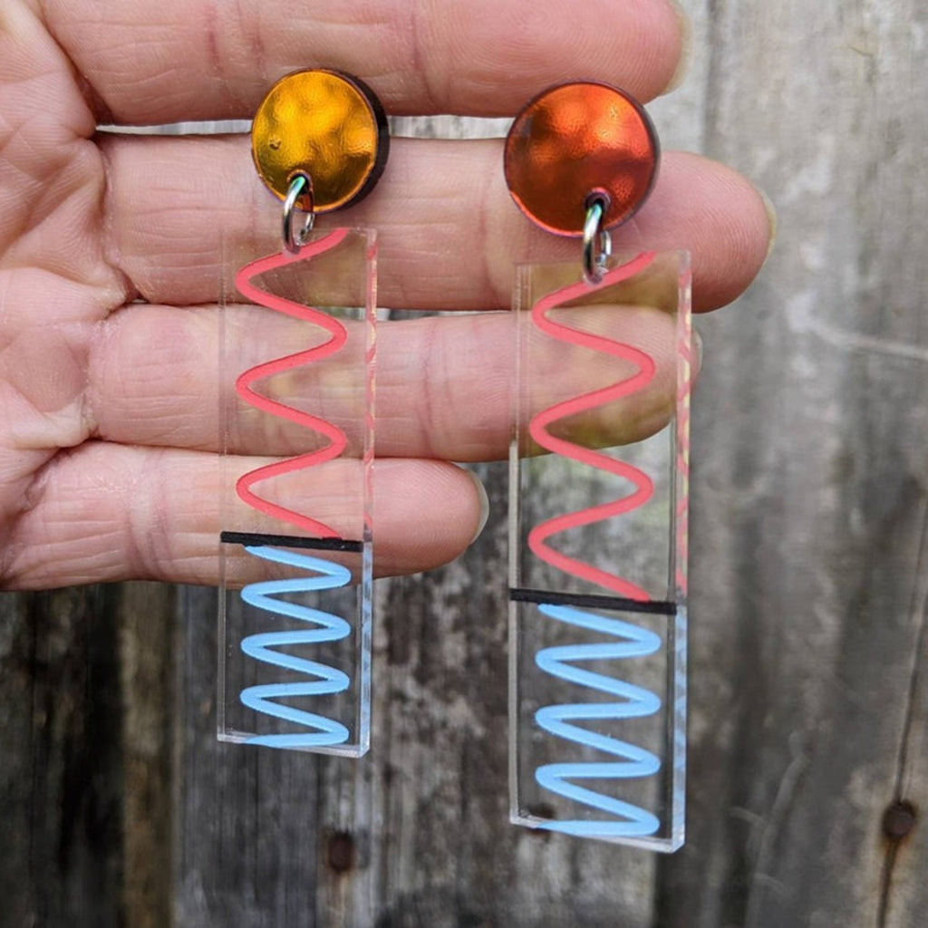 Laser cut acrylic doppler effect earrings, showing red and blue wavelength effects.
