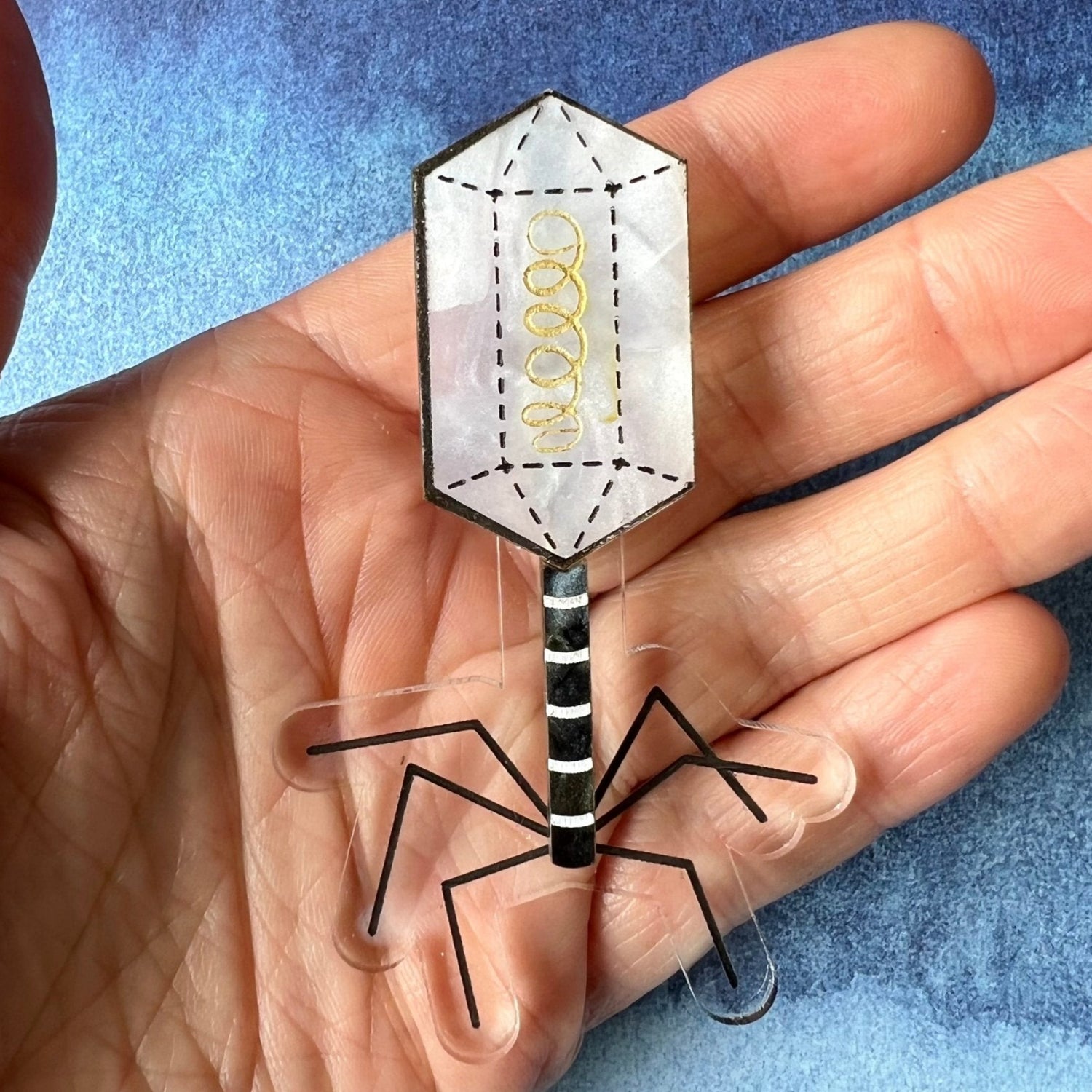 A virus (bacteriophage) brooch, handmade from laser cut acrylic.