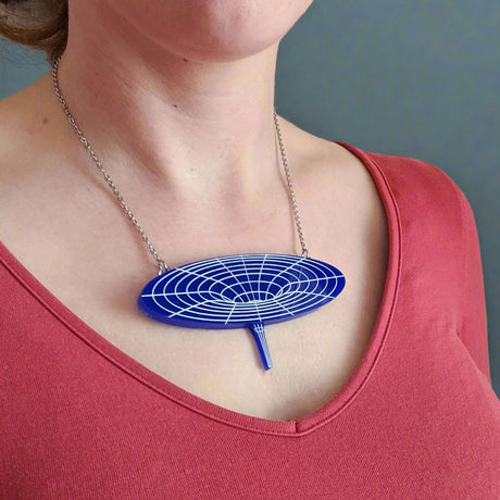 Dark blue black hole acrylic necklace being modelled. For Astronomy lovers. 